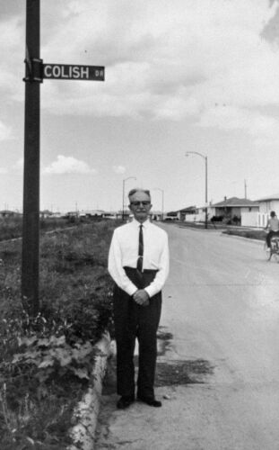 Isaac Colish under street sign named after him, Winnipeg, 1963