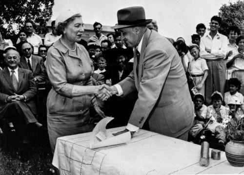 Moshe Kol hands deed to Sally Gotlieb during the dedication of Nahala in Negev, 1955